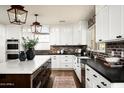Spacious kitchen with white cabinets, brick backsplash, and large island at 88 N Country Club Dr, Phoenix, AZ 85014