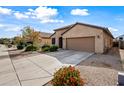Tan house with two-car garage and landscaping at 1095 W Desert Valley Dr, San Tan Valley, AZ 85143