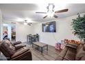 Spacious living room featuring brown leather couches and a large TV at 18202 N Cave Creek Rd # 115, Phoenix, AZ 85032