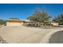 Single story home with a two-car garage and landscaped front yard at 12946 W Ashwood Dr, Sun City West, AZ 85375