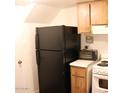 Kitchen area with black refrigerator and stove at 4622 N 71St Ln, Phoenix, AZ 85033