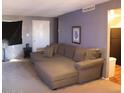 Spacious living room featuring a large sectional sofa and neutral color palette at 4622 N 71St Ln, Phoenix, AZ 85033