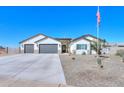 Beautiful Craftsman style home with a 3-car garage and desert landscaping at 6608 N Loma Ct, Casa Grande, AZ 85194