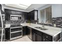 Modern kitchen with dark cabinets and double oven at 1825 W Ray Rd # 1001, Chandler, AZ 85224