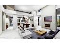 Open living area with fireplace, kitchen, and high ceilings at 28083 N 109Th Way, Scottsdale, AZ 85262