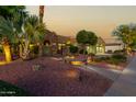 Landscaped yard with a walkway leading to a two-story home at 13232 W Los Bancos Dr, Sun City West, AZ 85375