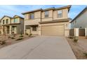 Two-story house with a beige exterior, two-car garage, and landscaping at 31751 N Velvet Rush Rd, San Tan Valley, AZ 85143
