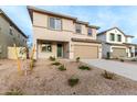 Two-story house with a beige exterior, two-car garage, and landscaping at 31751 N Velvet Rush Rd, San Tan Valley, AZ 85143