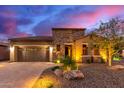 Single-story home with stone accents and desert landscaping at 28694 N 127Th Ln, Peoria, AZ 85383