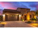 Single-story home with stone accents and desert landscaping at 28694 N 127Th Ln, Peoria, AZ 85383
