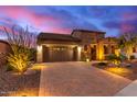 Single-story home with stone accents and desert landscaping at 28694 N 127Th Ln, Peoria, AZ 85383