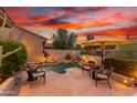 Inviting backyard pool with patio furniture and sunset backdrop at 33231 N 72Nd Pl, Scottsdale, AZ 85266