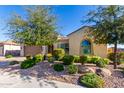 House exterior showcasing landscaping and driveway at 5771 W Cinder Brook Way, Florence, AZ 85132