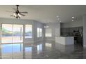 Open concept living room with kitchen and tile flooring at 27824 N 256Th Ave, Wittmann, AZ 85361