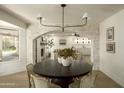 Elegant dining room with round table and stone accent wall at 9862 E San Salvador Dr, Scottsdale, AZ 85258