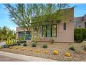 Modern home with stone and stucco exterior, attached garage, and desert landscaping at 37200 N Cave Creek Rd # 1082, Scottsdale, AZ 85262