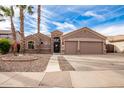 Two-story house with a three-car garage and desert landscaping at 568 N Falcon Dr, Gilbert, AZ 85234