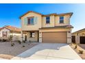 Two-story house with tan exterior, light green shutters, and a two-car garage at 7499 E Sweet Honey Ln, San Tan Valley, AZ 85143