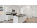 Modern kitchen with granite island and stainless steel appliances at 38100 W Excussare Way, Maricopa, AZ 85138