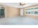 Bright and airy living room with neutral carpeting and ceiling fan at 4658 E Capri Ave, Mesa, AZ 85206