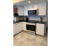 Updated kitchen with stainless steel appliances and white cabinetry at 272 Leisure World --, Mesa, AZ 85206