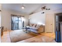 Bright living room featuring hardwood floors and access to a balcony at 2025 E Campbell Ave # 330, Phoenix, AZ 85016