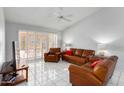 Living room with leather furniture and access to patio at 8333 W Wescott Dr, Peoria, AZ 85382