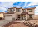 Two-story house with a large driveway and landscaping at 18309 W Desert Ln, Surprise, AZ 85388