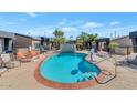 Community pool with lounge chairs and surrounding landscaping at 3233 N 37Th St # 9, Phoenix, AZ 85018