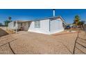 Single-wide manufactured home with carport and landscaped yard at 530 S 98Th Way, Mesa, AZ 85208