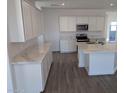 Modern kitchen with white cabinets, quartz counters, and island at 48466 N Duran Way, Gold Canyon, AZ 85118