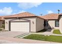 Home's exterior features a two-car garage and a well-manicured lawn at 1712 N Miller Rd, Scottsdale, AZ 85257