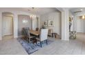 Bright dining area with wood dining table, modern light fixture, and access to kitchen at 2340 W Horsetail Trl, Phoenix, AZ 85085