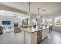 Open concept kitchen with large island and views to living areas at 2340 W Horsetail Trl, Phoenix, AZ 85085