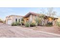 Single story home with attached garage and desert landscaping at 4549 E Marion Way, Phoenix, AZ 85018