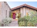 Inviting entryway with red door and lush landscaping at 4549 E Marion Way, Phoenix, AZ 85018