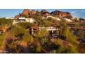 House nestled on hillside with red rocks and city views at 4549 E Marion Way, Phoenix, AZ 85018