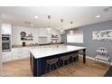 Modern kitchen with island, white cabinets, and quartz countertops at 3413 N 16Th N Dr, Phoenix, AZ 85015