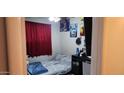 Cozy bedroom with a double bed and posters on the wall at 2616 N 50Th Ave, Phoenix, AZ 85035