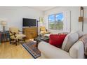 Bright living room with hardwood floors and comfy seating at 2201 N Central Ave # 4E, Phoenix, AZ 85004