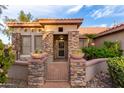 Inviting front exterior with stone accents and landscaped entryway at 15101 W Waterford Dr, Surprise, AZ 85374