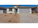 New construction home with gray garage door and drought-tolerant landscaping at 7400 E White Tail Rd, San Tan Valley, AZ 85143