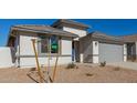New construction home with gray garage door and small front yard at 7400 E White Tail Rd, San Tan Valley, AZ 85143