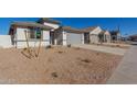 Modern, single-story home with gray garage door and gravel landscaping at 7400 E White Tail Rd, San Tan Valley, AZ 85143