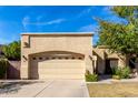 Tan stucco house with a two-car garage and well-manicured lawn at 5505 E Mclellan Rd # 9, Mesa, AZ 85205