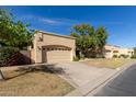 View of a community of tan stucco houses with lush landscaping at 5505 E Mclellan Rd # 9, Mesa, AZ 85205