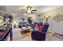 Living room with leather reclining sofas and tile floor at 17447 N 99Th Dr, Sun City, AZ 85373