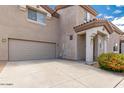 Tan two-story townhome with a garage and landscaping at 7959 W Waltann Ln, Peoria, AZ 85382