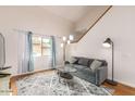 Cozy living room featuring a gray couch and glass coffee table at 7959 W Waltann Ln, Peoria, AZ 85382