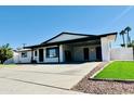 Modern home with covered carport and well-manicured lawn at 1737 N Trevor Dr, Mesa, AZ 85201